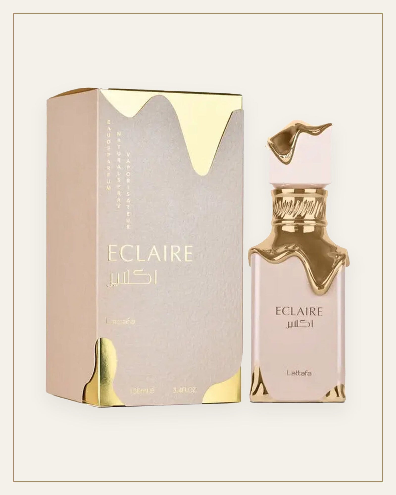 Frasco y estuche de Lattafa Eclaire Eau de Parfum sobre fondo arena
